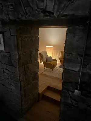 a view of a living room with a stone wall at The Church Tower in Crieff