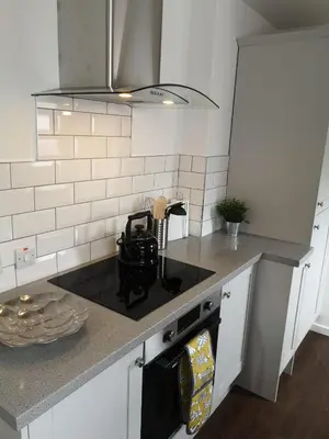 a kitchen with a stove and a counter top at The Mila - Ayr Racecourse - Coorie Doon Stays in Ayr