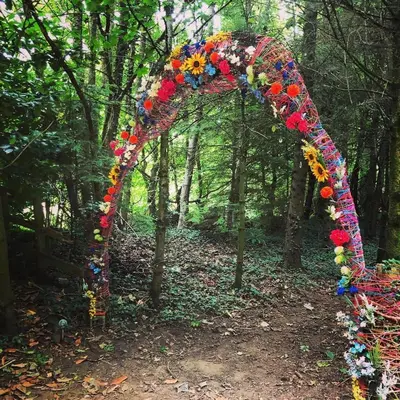 a floral arch in the middle of a forest at Ayrshire Airstream in Galston