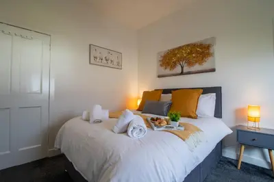 a bedroom with a bed with a dog on it at Bella House - 3 bed house in Glasgow in Glasgow