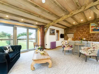 a living room with couches and a table at Knock Old Castle in Largs