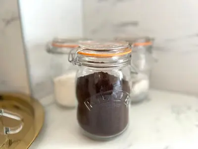 a glass jar filled with brown liquid on a counter at Bellevue Apartment in Largs
