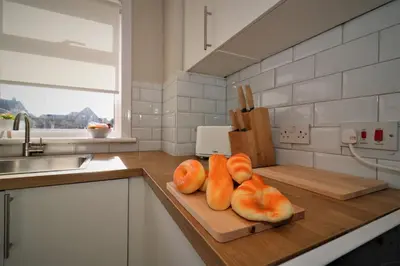 a kitchen with a cutting board with oranges on it at Signature - Honeywell House in Chapelhall