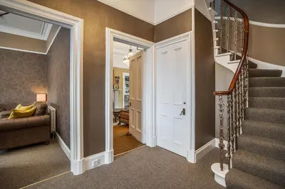 a hallway with a stairway leading up to a room at Annfield House, Callander in Callander