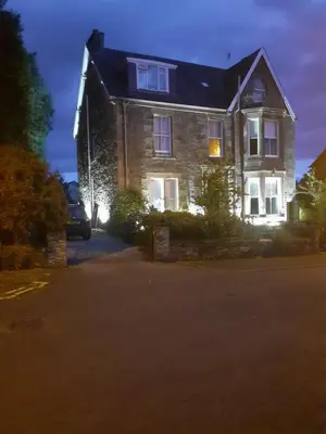 a large house with lights on the front of it at Annfield House, Callander in Callander