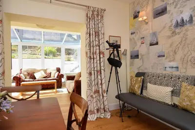 a living room with a camera on a tripod at The Neuk in Tighnabruaich