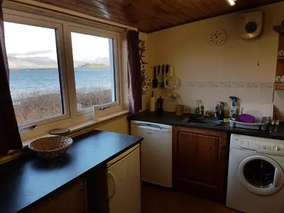 a kitchen with a sink and a washing machine at The Old Ferryhouse in Port Appin