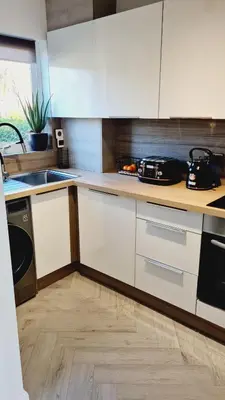 a kitchen with white cabinets and a sink at Beautiful 2bed house with garden, walking distance to town - FREE parking in Glasgow