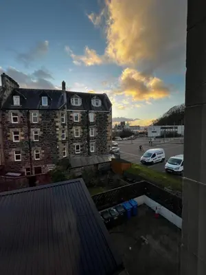 a view of a building with cars parked in a parking lot at Dunarle Guesthouse in Oban