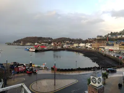 a city with a large body of water and a town at Station View in Oban