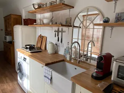 a kitchen with a sink and a washing machine at Ballachulish House Apartment in Ballachulish