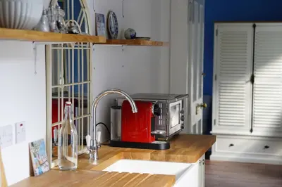 a kitchen with a sink and a microwave on a counter at Ballachulish House Apartment in Ballachulish