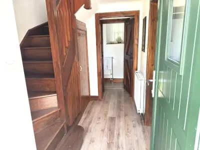 a hallway with wooden floors and stairs in a house at The Bothy of Ballachulish House in Ballachulish