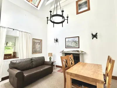 a living room with a couch and a table at The Bothy of Ballachulish House in Ballachulish