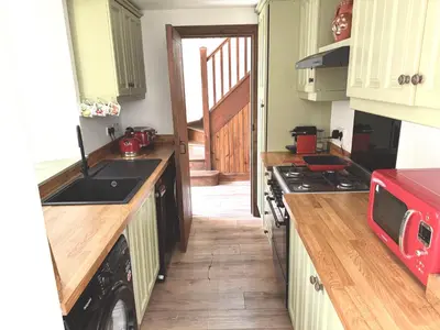 a kitchen with a sink and a stove top oven at The Bothy of Ballachulish House in Ballachulish