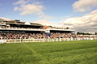 a large crowd of people watching a horse race at Beautiful 2 to 3 bed apartment with stunning views! in Ayr
