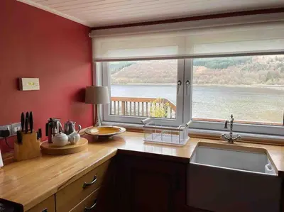 a kitchen with a sink and a large window at Viking Cottage in Arrochar