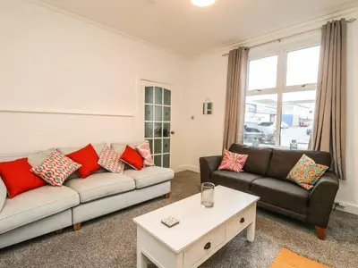 a living room with two couches and a coffee table at Annielea is a cosy 3 bed Cottage in Helensburgh in Helensburgh