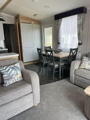 a living room with a couch and a table and chairs at Swift Bordeaux 67 in Dunoon