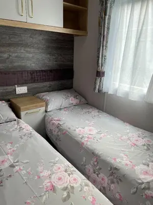 a bedroom with two beds and a window at Swift Bordeaux 67 in Dunoon