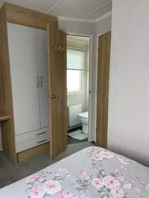 a bedroom with a bed and a bathroom with a toilet at Swift Bordeaux 67 in Dunoon