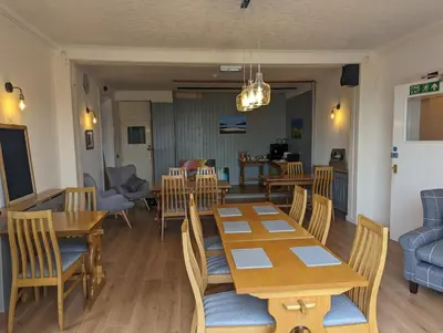 a dining room with wooden tables and chairs at Lochaline Hotel in Lochaline