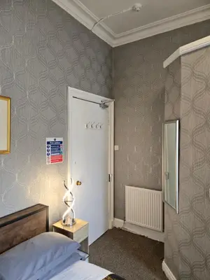 a bedroom with a bed and a white door at the CITY- Braveheart House in Edinburgh