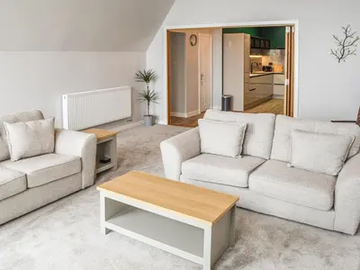 a living room with two couches and a coffee table at Gleaner Lea Apartment in Campbeltown
