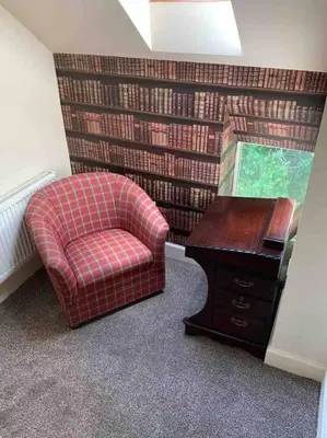 a room with a chair and a desk and a desk at The Apartment - Chandlers in Ascog