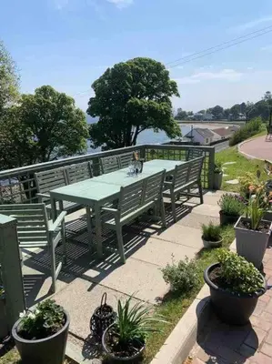 a picnic table with a dog sitting on top of it at The Apartment - Chandlers in Ascog