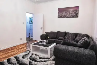 a living room with a couch and a coffee table at Glasgow Southside: Cosy 2 Bedroom Apartment in Glasgow