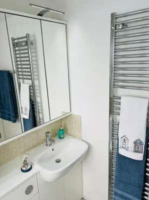a bathroom with a sink and a mirror at Riverside View Penthouse in Balloch, Loch Lomond in Balloch
