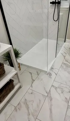 a white marble bathroom with a glass shower stall at Holly Lodge - 2 x Kingsize bedrooms with private entrance and free parking-new shower room in Oban