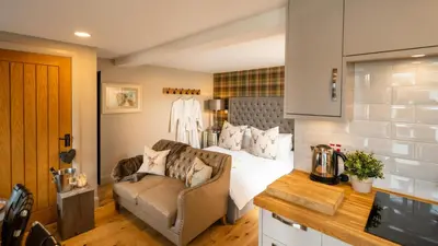 a living room with a bed and a couch at Nether Glenny Farm in Stirling