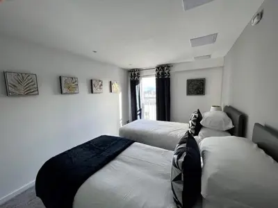a bedroom with two beds and a window at Modern & Spacious 2 bed Merchant City Apart-High St in Glasgow