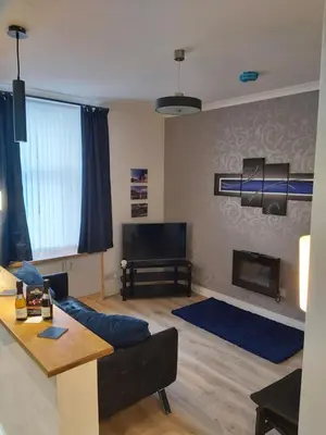 a living room with a couch and a fireplace at One bedroom flat, very close to Town center. in Oban