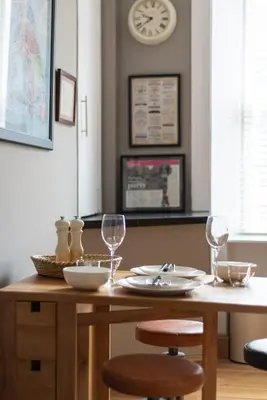 a dining room table with two chairs and glasses at Charming Grassmarket 1 Bed Castle pad in Edinburgh