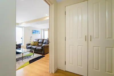 a door leading into a living room with a couch at Bell Street Apartments in Glasgow