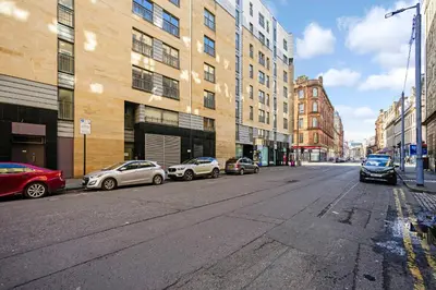 a group of cars parked on a city street at Bell Street Apartments in Glasgow