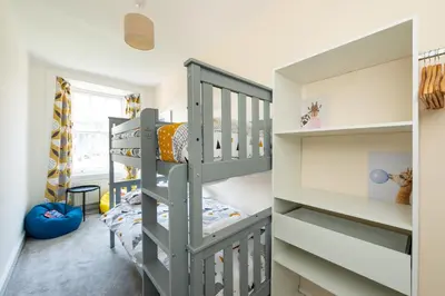 a childs room with bunk beds and a staircase at Lovely 3 bed apartment in central Edinburgh in Edinburgh
