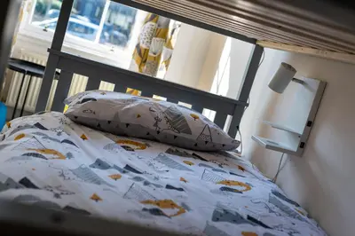 a bedroom with a bed with a pillow and a window at Lovely 3 bed apartment in central Edinburgh in Edinburgh