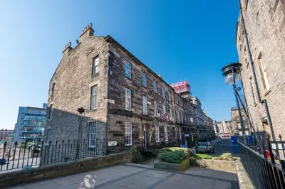 an old brick building on the side of a street at Lovely 3 bed apartment in central Edinburgh in Edinburgh