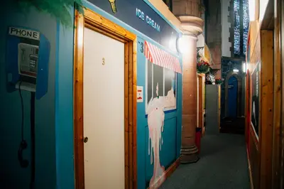 a hallway with a door with a picture of a baseball player at Belford Hostel in Edinburgh