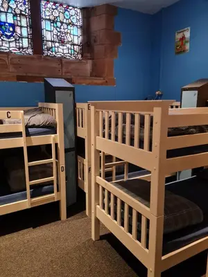 two bunk beds in a room with a stained glass window at Belford Hostel in Edinburgh