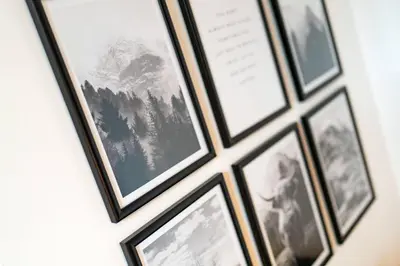 a bunch of framed photos hanging on a wall at The Tollbooth in Clackmannan