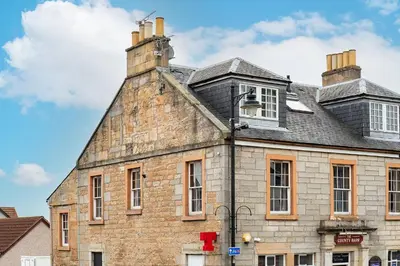 an old brick building with a chimney on top of it at The Tollbooth in Clackmannan