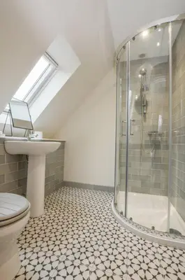 a bathroom with a shower and a toilet and a sink at Blackmount House in Oban