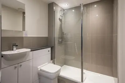 a bathroom with a shower and a toilet and a sink at Artist's Studio in Stockbridge in Edinburgh