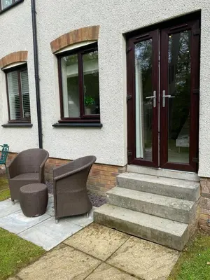 a house with two chairs and a door at Gleneagles Holiday Home in Auchterarder