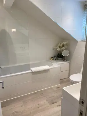 a white bathroom with a tub and a toilet at Gleneagles Holiday Home in Auchterarder